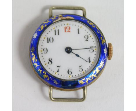 An early 20thC silver and enamel watch head, raised with gilt coloured flowers and marked silver, with fancy 2.5cm diameter A