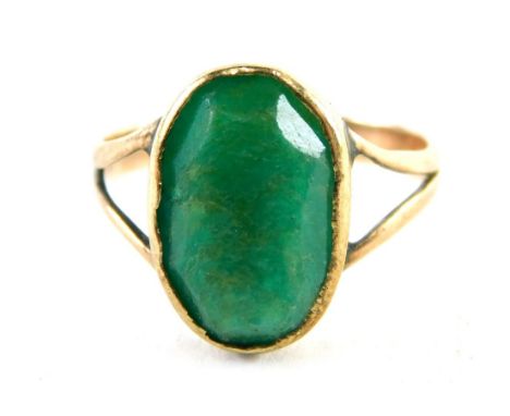 A 9ct gold polished jade dress ring, the oval jade in a rubover setting with V splayed shoulders, ring size K½, 1.9g all in.