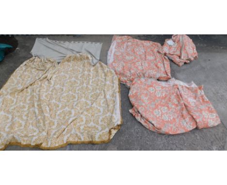 A pair of full length curtains, in patterned coral coloured fabric.  