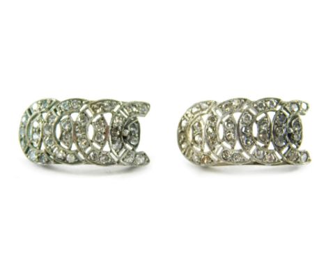 A pair of Art Deco diamond drop earrings, each of a curved drop with four row horseshoe type design, set with tiny diamonds i