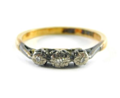 An 18ct gold diamond dress ring, with three illusion set tiny diamonds in white gold setting on a yellow metal band, ring siz