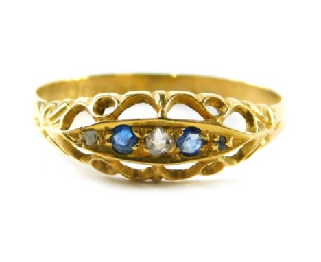 An 18ct gold sapphire and diamond gypsy ring, set with three round brilliant cut diamonds and two sapphires, on a scroll desi