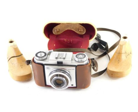 A pair of unusual child's shoe lasts, with articulated centres, and a Zeiss Ikon Contina camera, with 1:2.8f=45mm lens, 8cm h