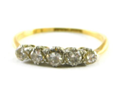 An 18ct gold five stone diamond dress ring, with five round brilliant cut stones, each in claw setting, on a thin yellow gold