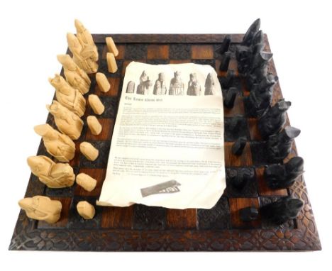 A Lewis Androil chess set, with 10cm high white king and heavily carved board. 