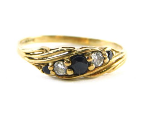 A 9ct gold sapphire and diamond dress ring, set with three sapphires and two diamonds, raised basket setting, ring size P½, 1