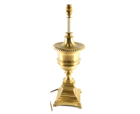 A 20thC brass urn table lamp, on inverted stem with square base terminating in stylised paw feet, 59cm high.