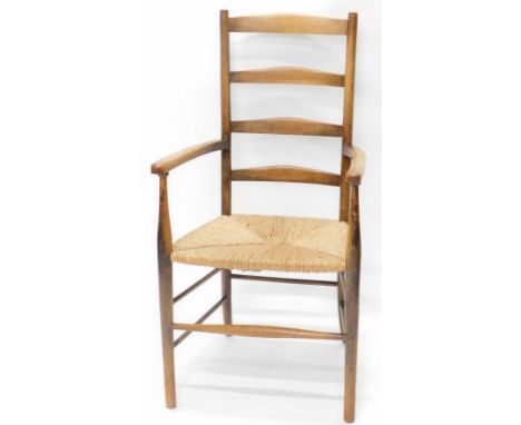 A late 19th/early 20thC beech Arts &amp; Crafts style ladder back chair, with a rush seat, on turned legs.