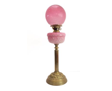 A 19th century brass and opaline glass mounted oil lamp: the spherical etched shade above an opaline glass reservoir decorate