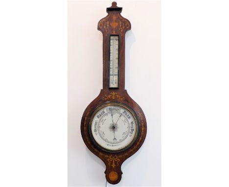 A late 19th century wheel aneroid barometer: inlaid with boxwood with scrolling foliage and flames above a thermometer and a 