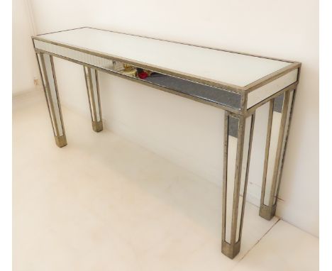 A modern mirror-topped and fronted console table from OKA: raised on square tapering legs: distressed 'antique' finish (154 x