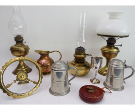 Eight pieces of metalware to include:two early 20th century brass oil lamps with their funnels;a similar oil lamp with a dome