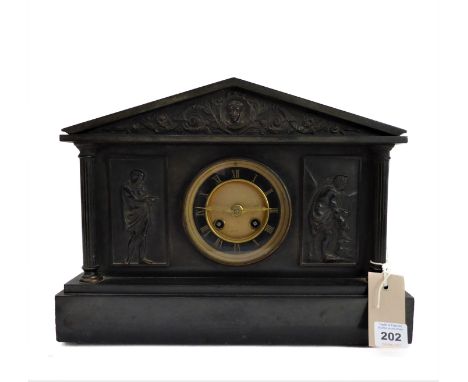 A late 19th century black slate eight-day mantle clock of architectural design: the chapter ring with gilded Roman numerals a
