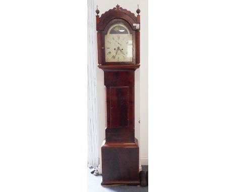 An early 19th century mahogany-cased eight-day longcase clock: the 12-inch arched dial surmounted with a 'wavy sea' style ped