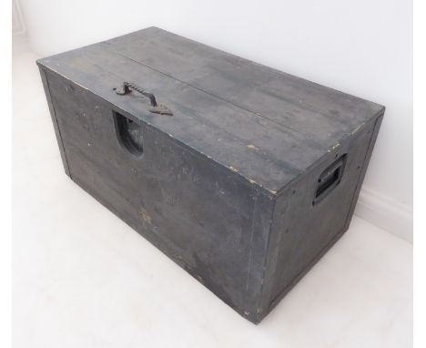 A painted pine trunk with hinged lid and two recessed carrying handles (85.5cm wide x 44cm deep x 43cm high)