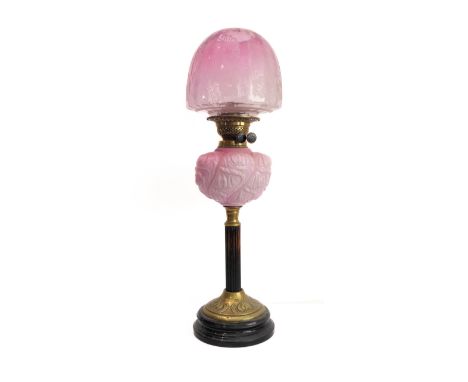 A 19th century brass mounted and opaline glass oil lamp: the dome-topped etched shade above a bulbous opaline glass reservoir