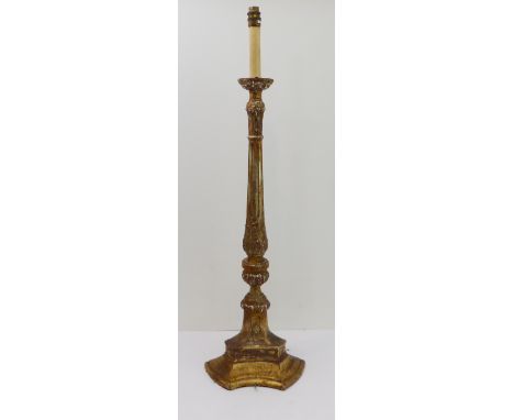 An early 20th century carved wood floor-standing lamp: turned fluted stem above an acanthus bulb and with triform base (89 cm