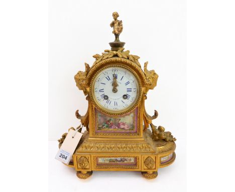 A 19th century gilt-metal and porcelain mounted eight-day mantle clock: the winged cherub surmount above a&nbsp; white-enamel