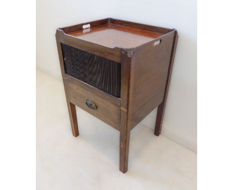 An 18th century tray-top mahogany commode: single full-width drawer above two cupboard doors and a slide-out sectional drawer