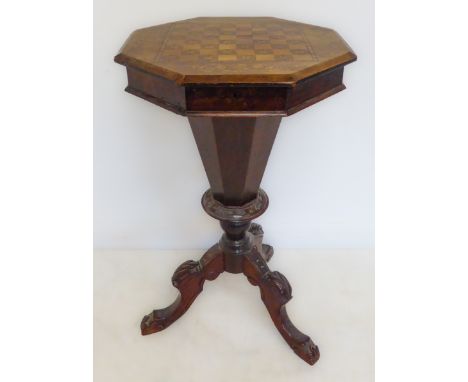 A 19th century octagonal walnut work-table with chessboard top: hinged lid opening to reveal varying compartments and a centr