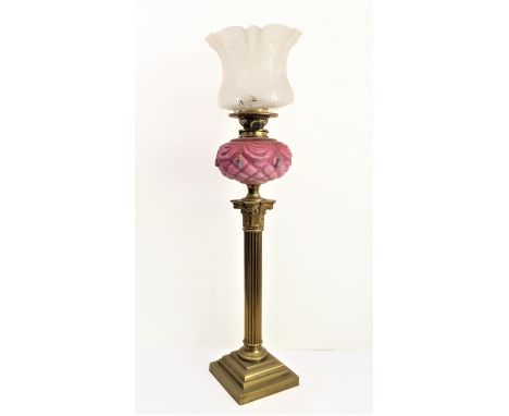A very large 19th century brass and opaline glass oil lamp: the frosted crimped and etched shade above a glass reservoir deco