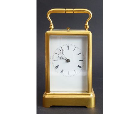 A fine quality gilt-metal and glass-sided carriage clock: white-enamel dial with Roman numerals, swing-handle to top, the gil