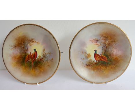 A pair of Crown Devon ceramic plates hand-decorated&nbsp;in the 'Game' pattern. One decorated with a cock pheasant,&nbsp; the