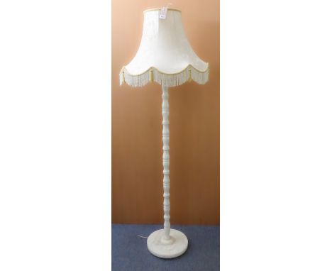 A white onyx lamp-standard on circular base. (137 cm high including electrical fitting.)