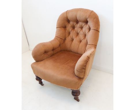 A 19th century light-brown Draylon upholstered button-back armchair raised on turned front legs with castorsCondition Report: