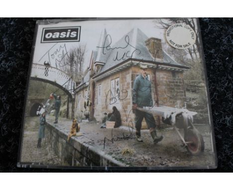 OASIS - promotional copy of the CD "Some Might Say" signed by all five of the original lineup to include Liam, Noel, Tony McC