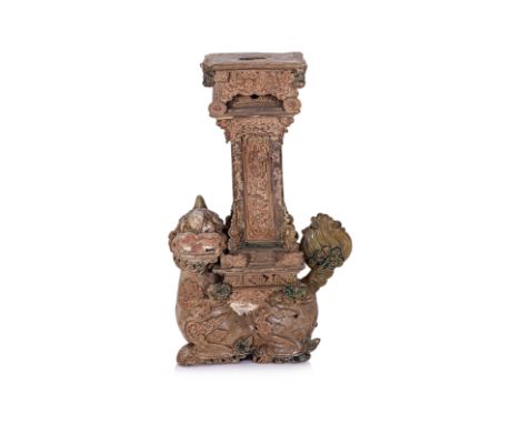 A VIETNAMESE STONEWARE CANDLEHOLDER WITH NGHE FORM BASE Bat Trang, Le Dynasty, early 16th/17th century, heavily potted green 