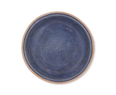 A VIETNAMESE BLUE MONOCHROME GLAZED DISH Circa 16th century, stoneware dish with raised lip, covered in a blue glaze apart fr