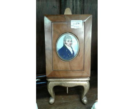 of a gentleman in three quarter pose, the oval portrait held in a polished walnut frame 