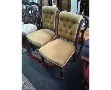 the button upholstered backs above padded seats supported by turned fluted legs 