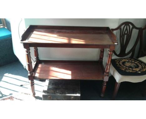 of rectangular form, the three quarter gallery rail on a moulded&nbsp;top supported by turned columns with a shelf stretcher 