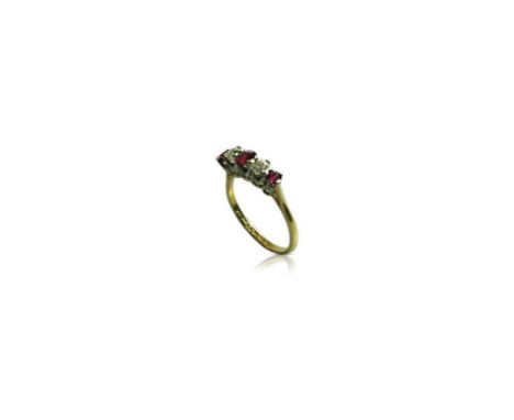 the large central ruby flanked by a pair of diamonds and two smaller rubies all held by a raised pierced mount supported by a