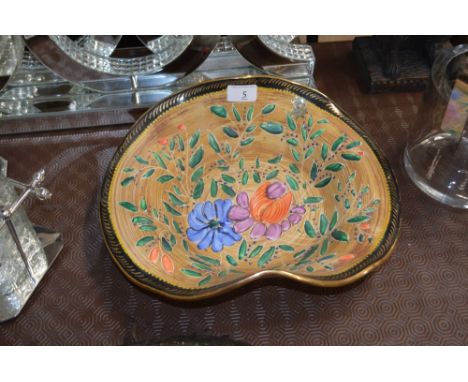 A Bequet hat shaped shallow bowl with brightly coloured enamel floral decoration and gilt rim 