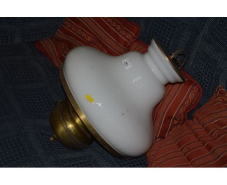 A brass hanging light fitting with milk glass shade 