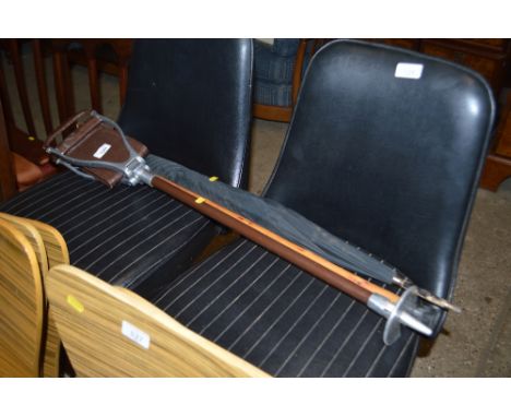 A shooting stick; a dogs head umbrella; and a dog head walking stick