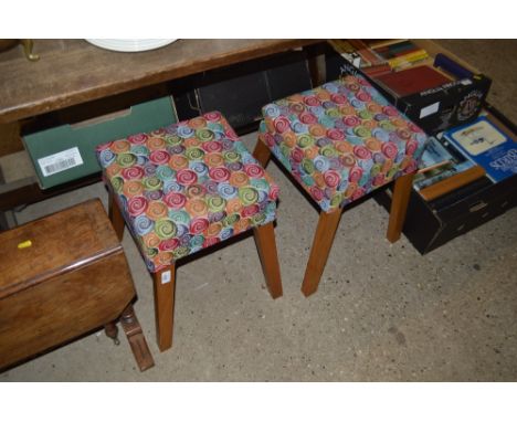 A pair of light oak stools upholstered in bold coloured swirling moquette