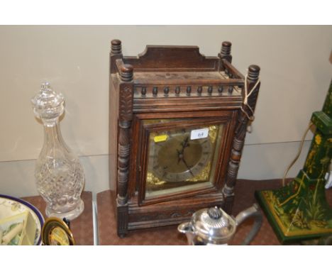 A 19th Century oak cased bracket clock with brass dial and eight day striking movement, key and pendulum on rostrum 
