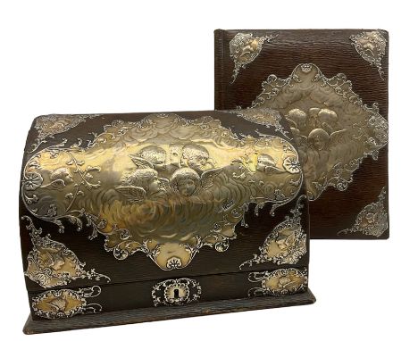 Edwardian leather and silver mounted stationery casket with hinged lid and silk lined divided interior decorated with cherub 