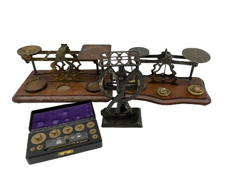 Set of Edwardian brass Postal Scales 'Inland Letter Post' on oak base, L29cm, another similar set with brass weights, set of 