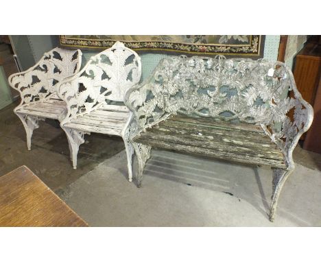 A metal alloy Coalbrookdale-style garden bench with slatted seats and pierced fern decoration, 110cm wide and a pair of match