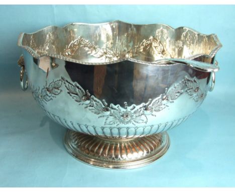 A large plated half-fluted Monteith with gadrooned rim, lion mask ring handles and chased with floral swags, on circular base