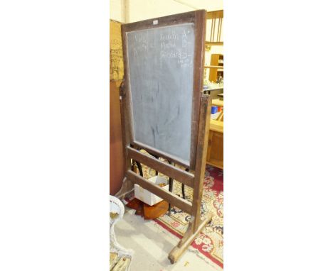 *A Victorian pitch pine schoolroom blackboard of rectangular shape, the rectangular board on cast iron gimbal mount, to the e