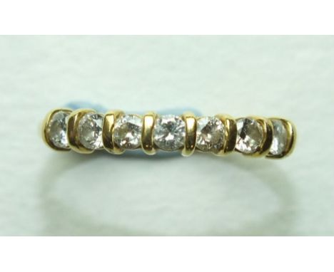 A diamond half-hoop ring set seven brilliant-cut diamonds, in 18ct yellow gold mount, size P, 2.4g.