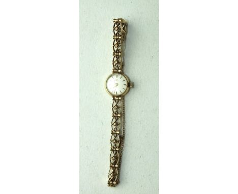 Tissot, a ladies 9ct gold wrist watch, the circular dial with baton numerals, on 9ct gold fancy-link bracelet, gross weight 1