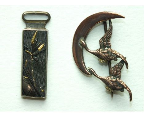 A small oblong Shakudo pendant with bamboo decoration, 32mm long, a brooch in the form of two geese flying across a crescent 