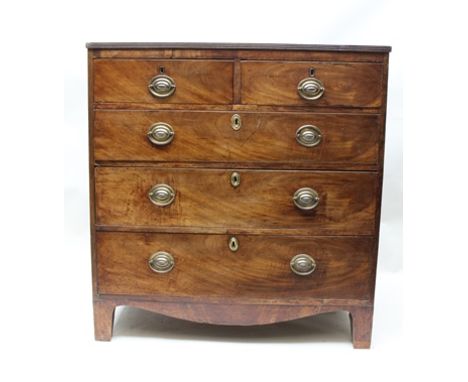 A 19TH CENTURY MAHOGANY CHEST of two short over three long graduated drawers, with oval brass handles with back plates, raise
